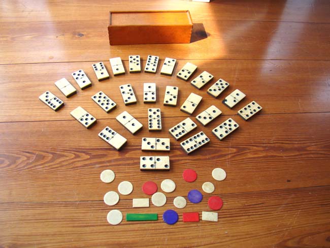 A fabulous 19th century set of bone and ebony dominoes along with bone gaming chips